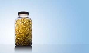 Image shows a vessel afloat of food lipid omega 3 and vitamin D supplement gel capsules.