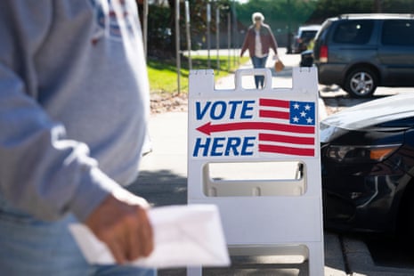 a sign reads 'vote here'
