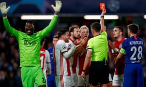 Ajax’s players react after Joël Veltman (hidden) is shown a red card by Italian referee Gianluca Rocchi.