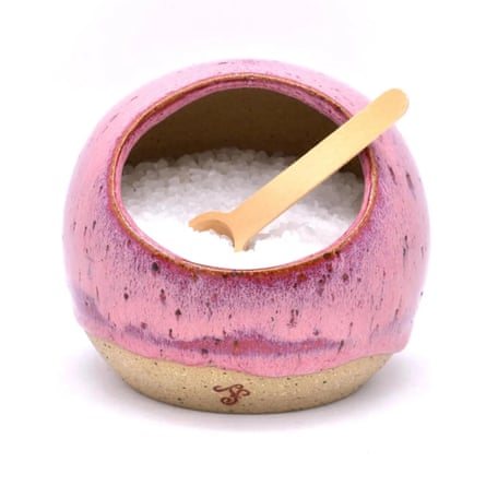 Handmade Ceramic Pottery salt pig. The salt pif is pink and natural clay. It is full of salt with a salt spoon.