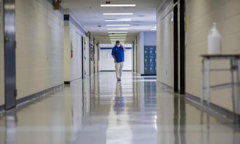 A middle school principal walks the empty halls of his school on 20 August 2021 in Wrightsville, Georgia.