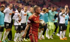 Aberdeen's Jonny Hayes leaves the field as Häcken players celebrate their aggregate win.