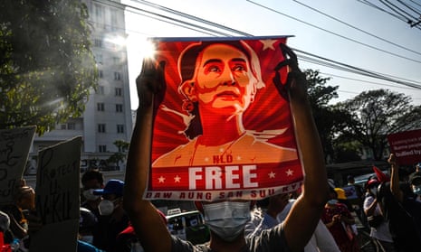A protester in Maynmar holds up a poster calling for the release of Aung San Suu Kyi, who faces fresh corruption charges