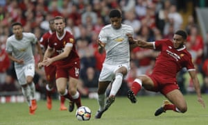 Joe Gomez stops the break from Marcus Rashford.