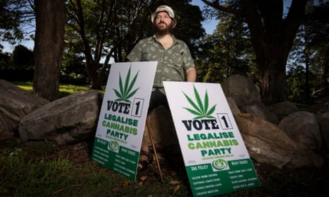 Antony Zbik holding legalise cannabis campaign posters