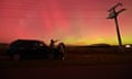 People watch the aurora australis, also known as the southern lights, in Rolleston on the outskirts of Christchurch on Saturday