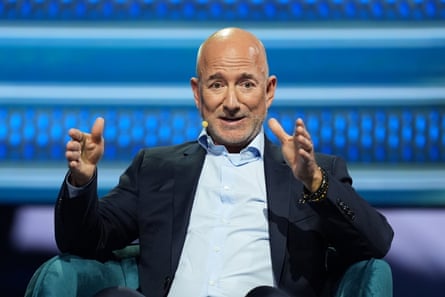 Man sits on stage and speaks