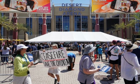 Protesters carry a placard calling for a ceasefire