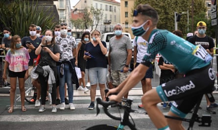 Tour de France spectators wearing face masks look on last summer