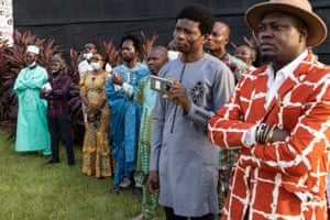 Benin artists listen to the minister of culture outside the exhibition, which closed in Cotonou in May