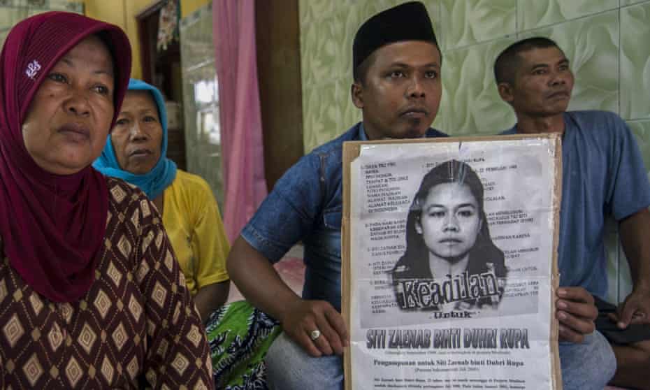 Family members of Indonesian maid Siti Zainab display a poster bearing her portrai. Siti Zainab was executed in April in Medina.