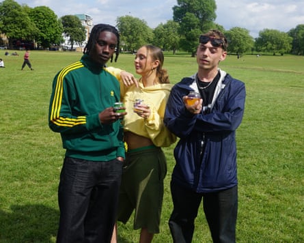 Carlo-Gino, Felicity Dunstan and Emil James drinking BuzzBallz successful Peckham Rye park, London
