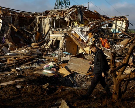 A member of local authority walks at the site of a private building which was heavily damaged during a Russian missile strike in the town of Vyshhorod.