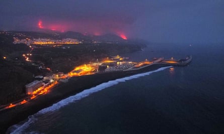 Lava is seen and smoke rises following the eruption of a volcano, in the Port of Tazacorte, on the Canary Island of La Palma