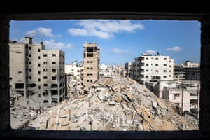A mound of rubble surrounded by damaged buildings