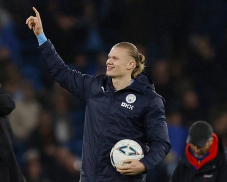 Manchester City's Erling Haaland celebrates with the match ball after the final whistle.