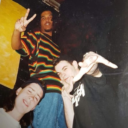 Danny Breaks, Ashley MC Special A and Dave Nodz pose on stage, flashing hand signs