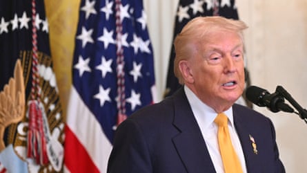 Donald Trump with American flags behind him
