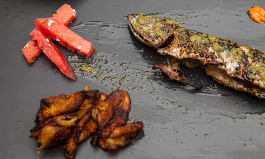 Carine’s mackerel with green sauce served with watermelon and deep-fried plantains.