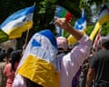 People with bright coloured flags protesting
