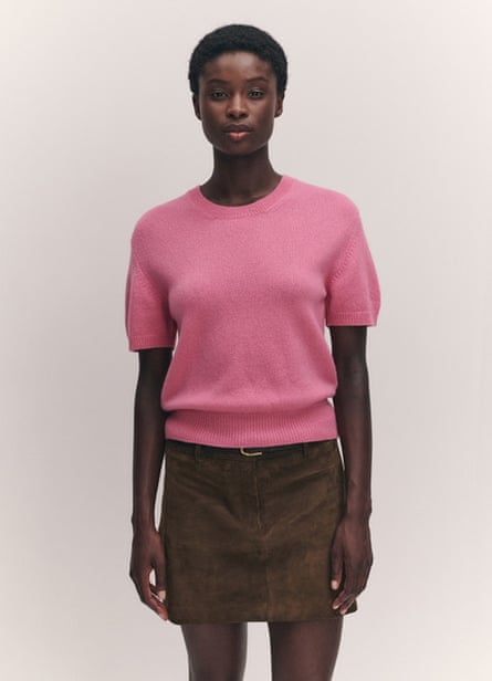 A model wearing a pink cashmere T-shirt with a brown suede skirt