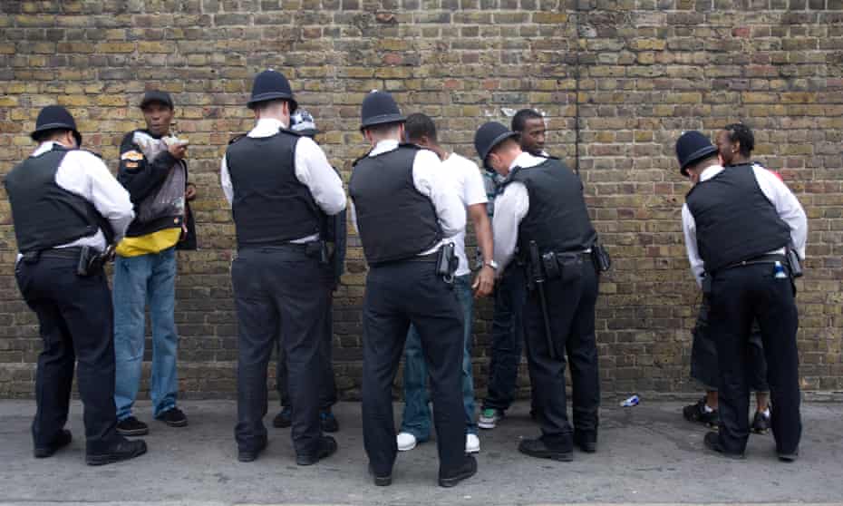 Police officers search black teenagers at Notting Hill Carnival in 2008