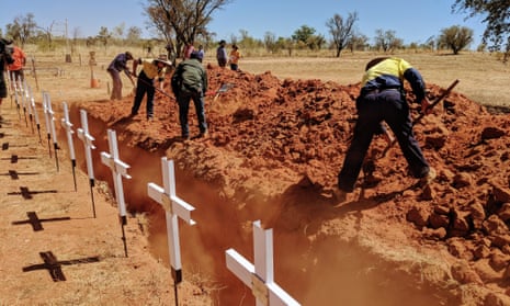 Local rangers start reburying the remains of more than 60 Aboriginal people whose graves were destroyed by floods 