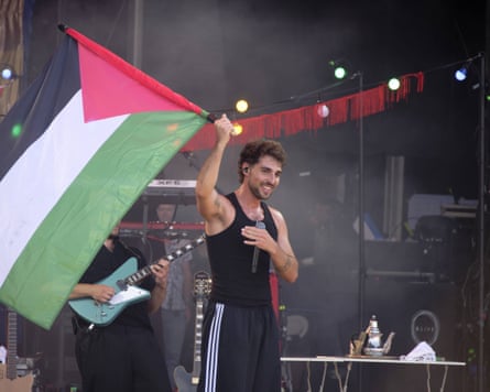 Saint Levant in concert waving Palestinian flag