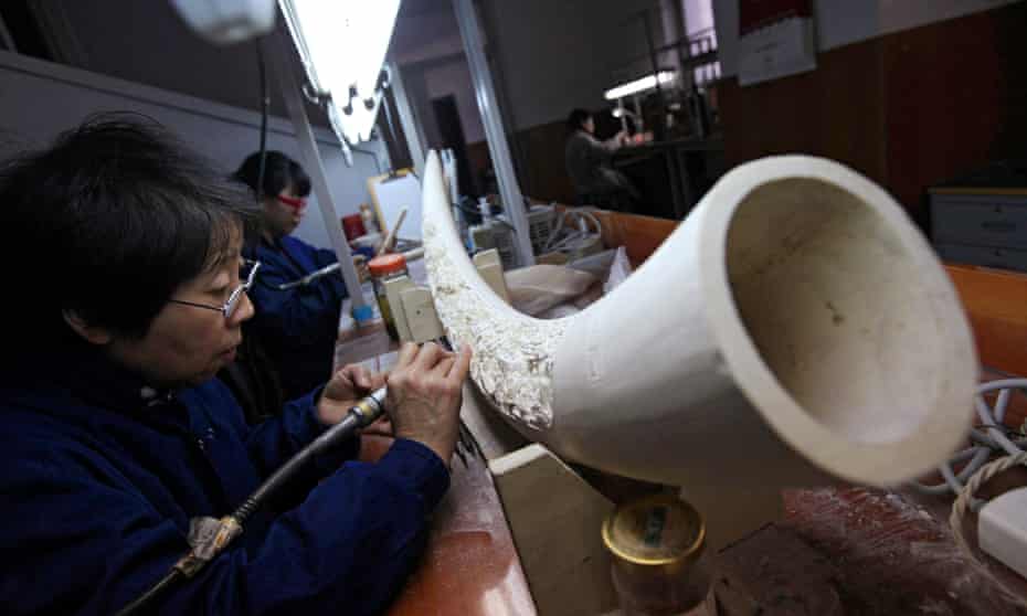 Chinese artists work on ivory sculptures in the Beijing Ivory Carving Factory in Beijing, China