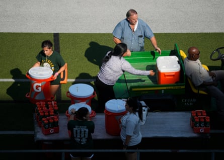 coaches with water coolers on the side of a football pitch