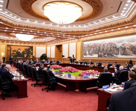 China’s President Xi Jinping (C-R) applauds as he hosts a meeting with global business leaders today