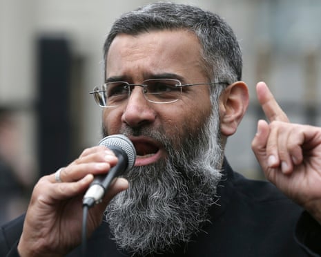 Anjem Choudary, who has grey hair and a grey beard, speaking while holding a microphone in 2015