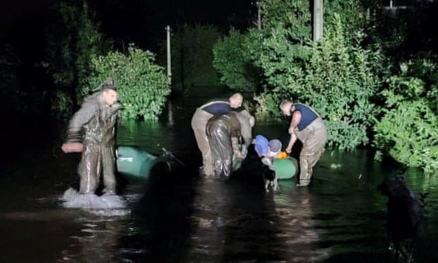 Rescuers help evacuate people from a flooded area of Kryvyi Rih.