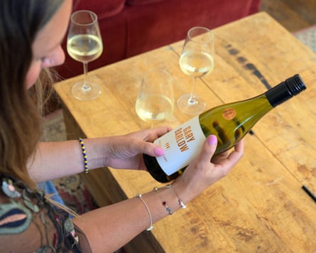 Jo Gould holds a bottle of Gary Barlow Wines sauvignon blanc
