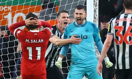 Newcastle United's Martin Dubravka celebrates with teammates after saving a penalty from Liverpool's Mohamed Salah.