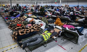 Ukrainian refugees sleep in a temporary shelter in an abandoned Tesco supermarket in Przemysl, Poland yesterday.