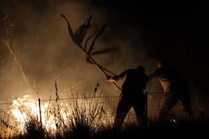 Forestry teams attempt to beat back flames