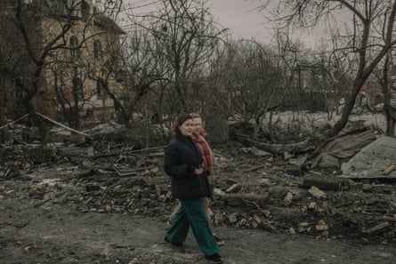 People walk through the site of a Russian missile strike on a residential area in Kyiv