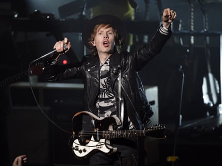 Singer Beck performs on stage dressed in black