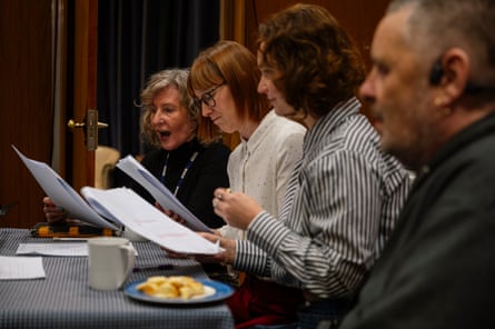 Four actors reading scripts.