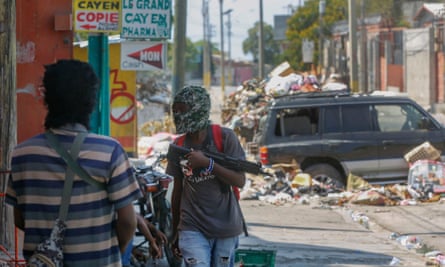 Armed members of the G9 Family gang stand guard at their roadblock in the Delmas 6 neighbourhood of Port-au-Prince, Haiti, 11 March 2024.