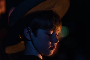 A child’s face is illuminated by the Eternal Flame at the Shrine of Remembrance during the Anzac Day dawn service in Melbourne.