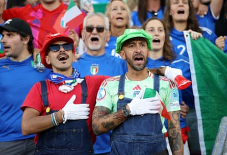Fans of Italy dressed as Super Mario and Luigi sing the national anthem before the semi-final against England.