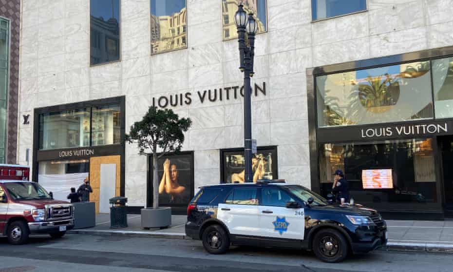 Police officers and emergency crews park outside the Louis Vuitton store in San Francisco's Union Square after looters ransacked businesses. 