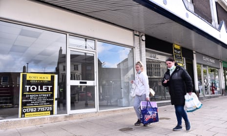 Shoppers walk past empty shops in Newcastle-Under-Lyme, England.