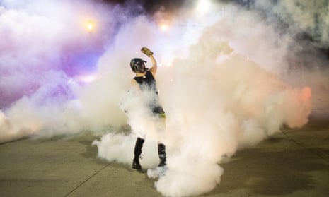 Protester holds a smoke canister during a night of clashes between protesters and Detroit police officers Saturday night.