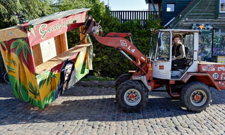 A Christiania resident removes a hash stall from Pusher Street, where up to 1bn krone changes hands every year.