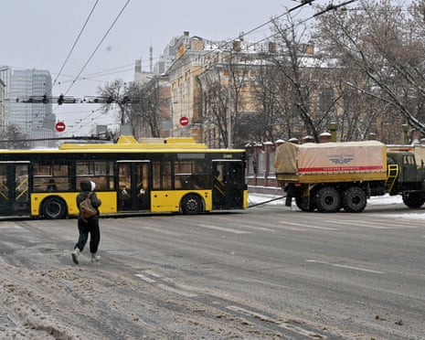 A truck tows a trolleybus due to lack of electricity during the blackout following Russian drones and missiles attacks in Kyiv.