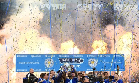 Captain Wes Morgan and manager Claudio Ranieri of Leicester City lift the Premier League Trophy as players and staff celebrate,