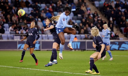 Khadija Shaw rises high to score Manchester City’s first goal against Tottenham.